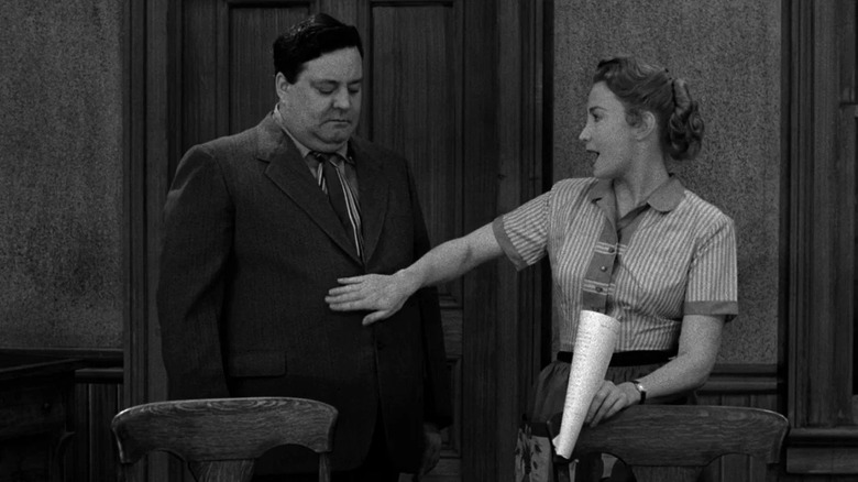 Alice patting Ralph on the stomach on The Honeymooners