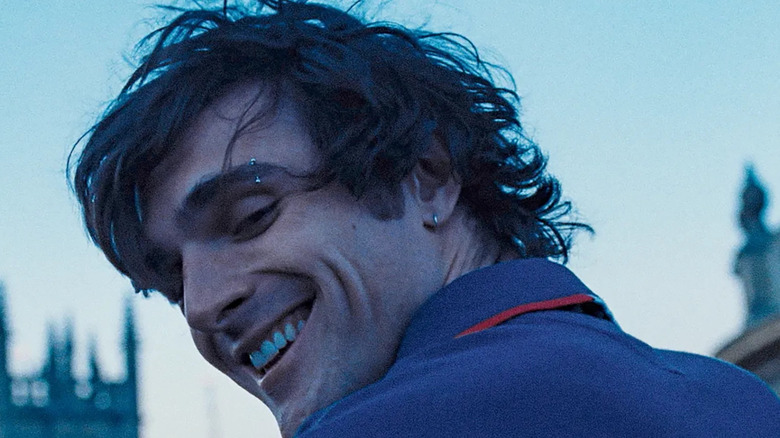 Jacob Elordi's Felix Catton smiles as he looks down in Saltburn
