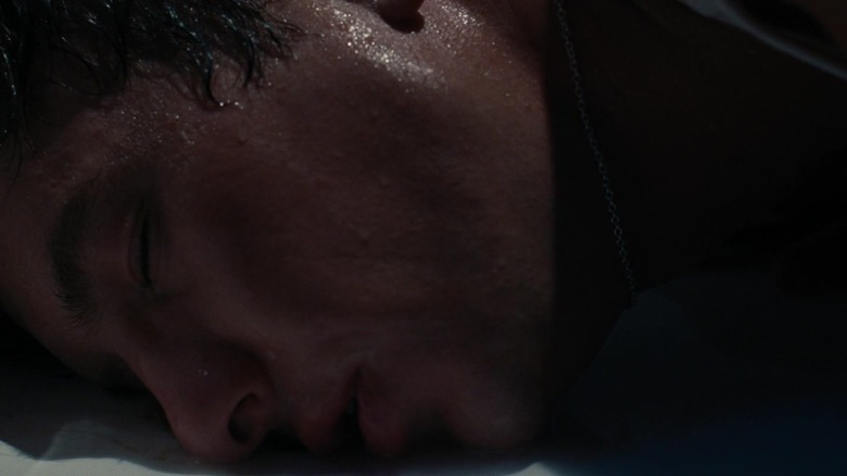 Barry Keoghan's Oliver Quick lays his head on the floor of a bathtub in Saltburn