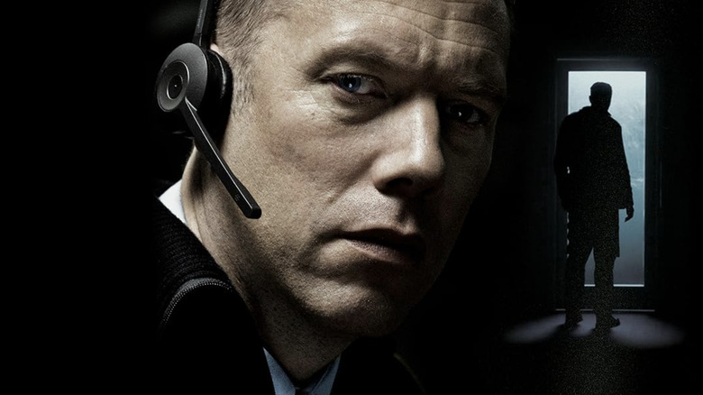 The comet poster, which appears closely to Asger Holm in the headphones and stands in the shade in front of the entrance