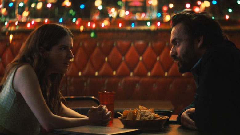 Anna Kendrick's Maddy sits opposite Jake Johnson's Tommy in a bar in Self Reliance