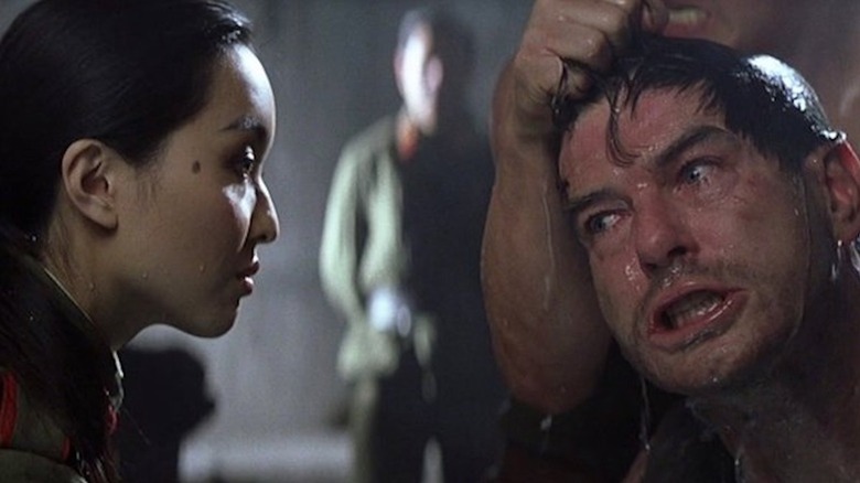 Tymarah as the Scorpion guard tortures Pierce Brosnan as James Bond in Die Another Day