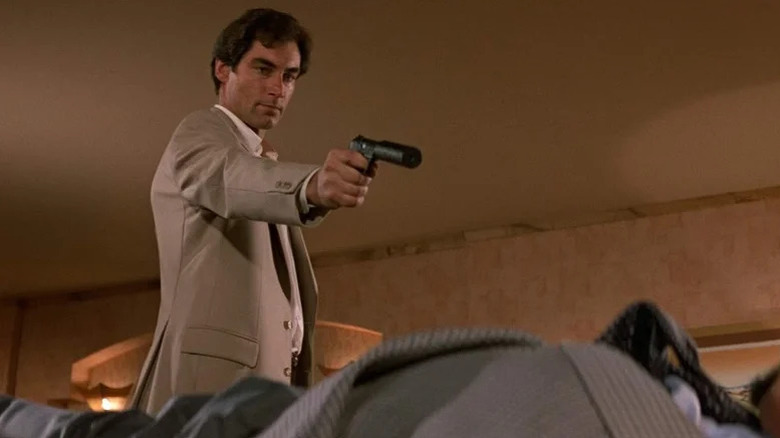 Timothy Dalton's James Bond pointing a gun in Living Daylights