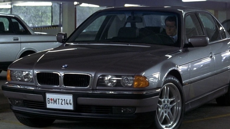 Pierce Brosnan as James Bond sitting inside the 1997 BMW 750iL in a parking garage in Tomorrow Never Dies