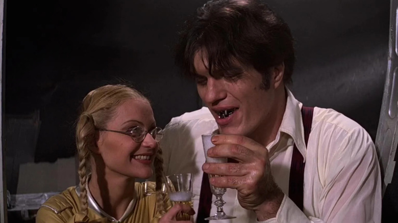 Jaws and Dolly holding champagne glasses in Moonraker
