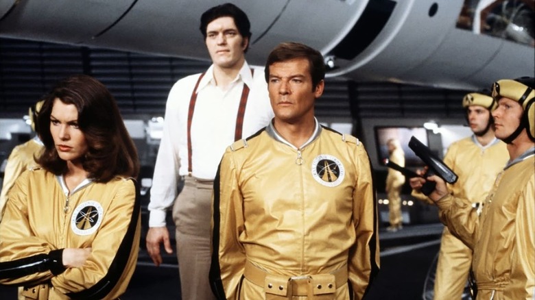 Roger Moore as James Bond wearing a yellow tracksuit in Moonraker