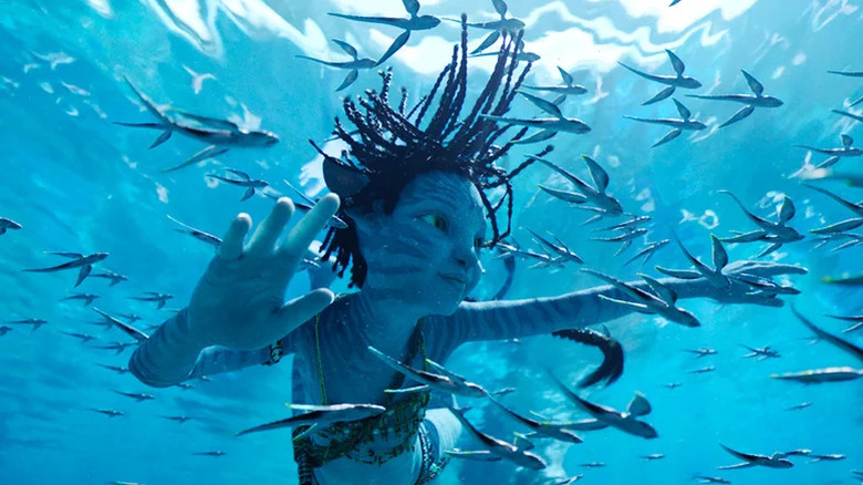 A Na'vi child swimming through a Pandora ocean in Avatar: The Way of Water