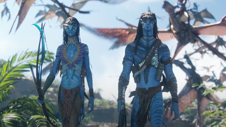 Neytiri and Jake walking into battle with dragons behind them in Avatar: Fire and Ash