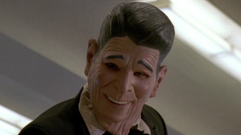 Patrick Swayze as Bodhi in the Ronald Reagan mask during a bank robbery in Point Break (1991)