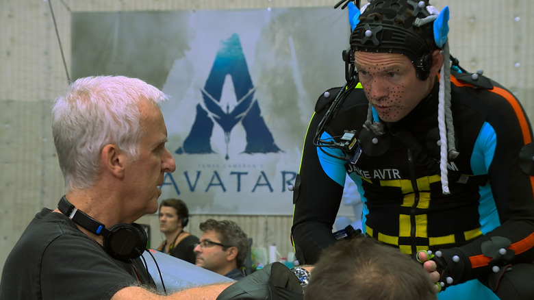 James Cameron directing Sam Worthington in a motion capture suit as Jake Sully in a behind-the-scenes image from Fire And Water: Making The Avatar Films