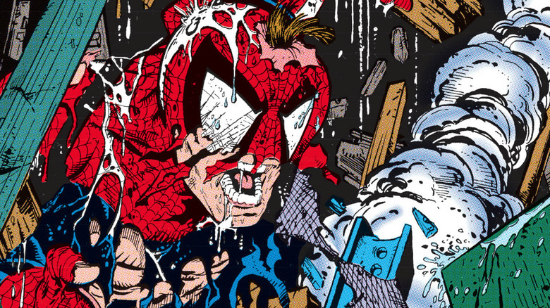 Spider-man is seen amid wreckage with half his mask missing in Spider-Man #1