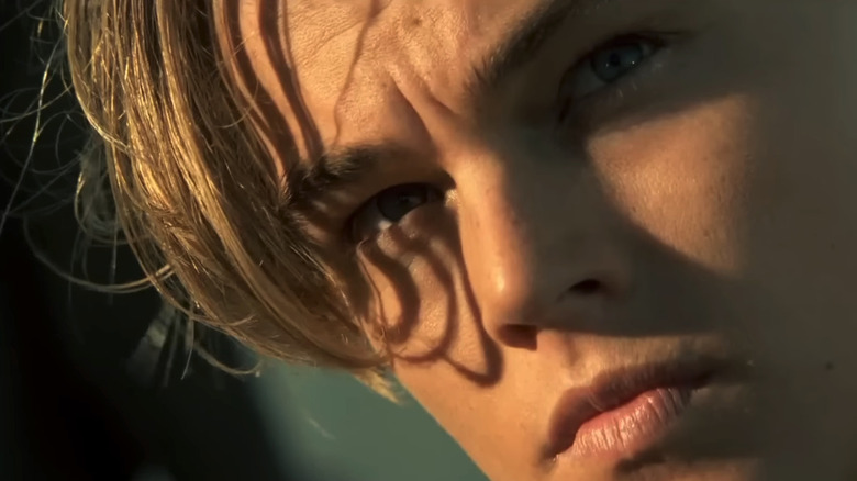 Leonardo DiCaprio's Jack Dawson is seen looking off into the distance in closeup in Titanic