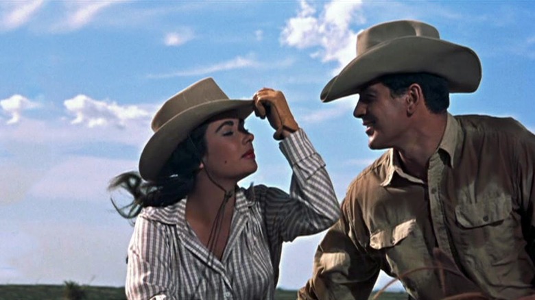 Leslie in a cowboy hat talking to Bick, also in a cowboy hat in Giant