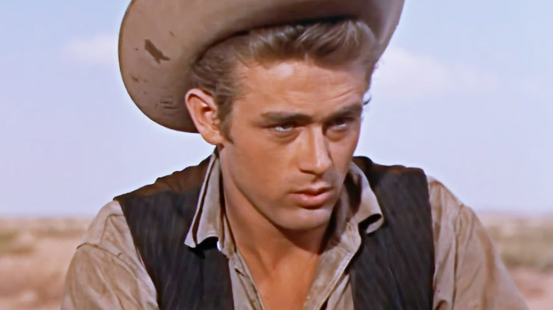Jett Rink wearing a cowboy hat with his shirt open in Giant
