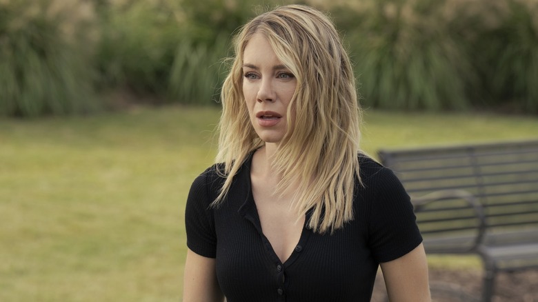 Jennifer Holland as Emilia Harcourt looking shocked in a park in Peacemaker season 2