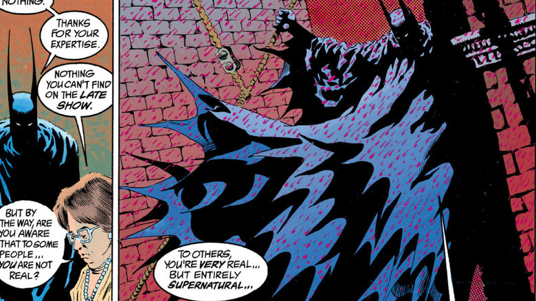 Batman perches on a building as drops of blood rain fall in a panel from Batman & Dracula Red Rain