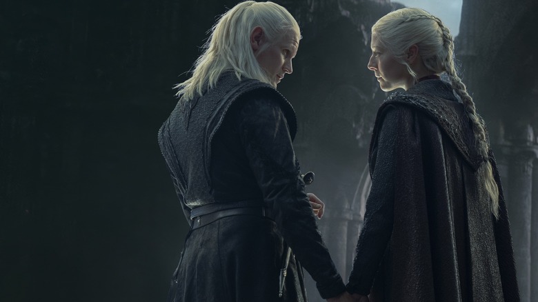 Matt Smith as Daemon Targaryen holding hands with Emma D'Arcy as Rhaenyra Targaryen in House of the Dragon