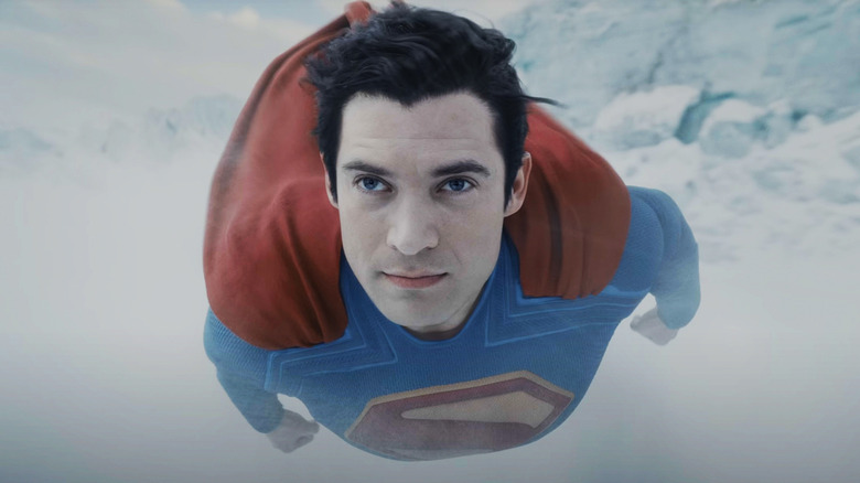 David Corenswet as Superman flies through a snowy environment in Superman