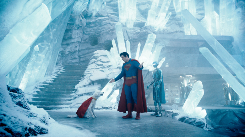 David Corenswet as Superman standing in the Fortress of Solitude next to Krypto the Superdog in Superman