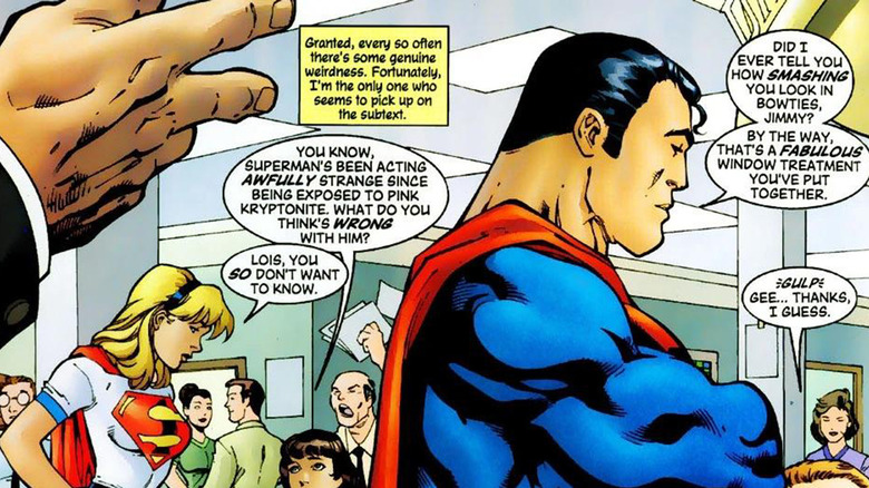 Superman is seen with his arms folded with Supergirl in the background