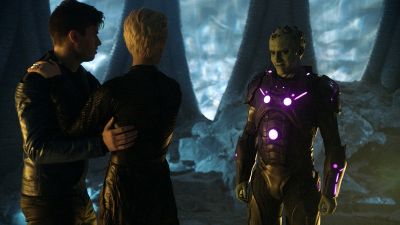 Krypton - Brainiac looking menacingly at two Kryptonians
