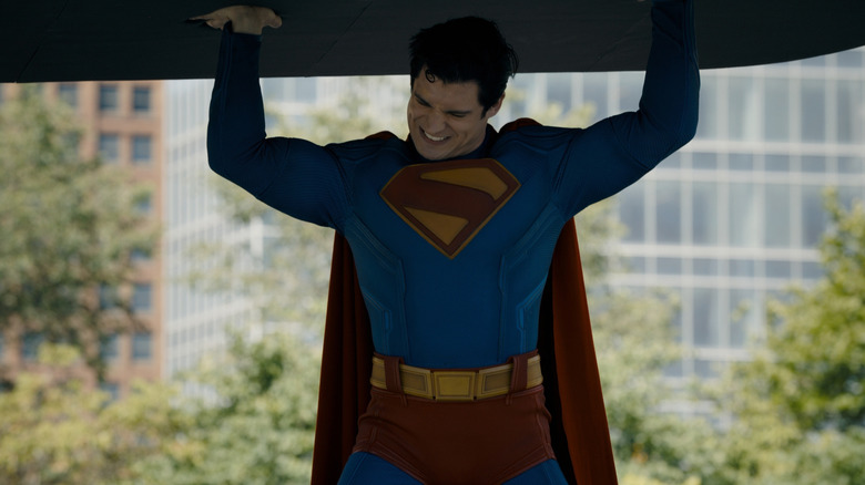 David Corenset as Superman lifting a very heavy object in Superman (2025)