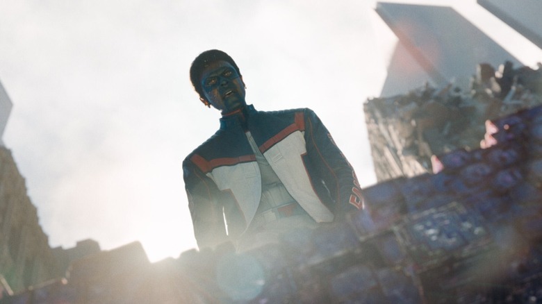 Edi Gathegi as Mr. Terrific looking down at Superman in the crater in Metropolis in Superman