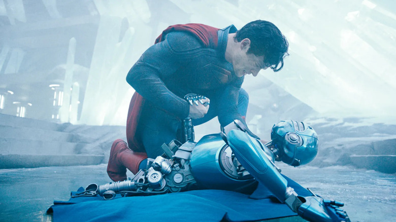 Superman holding a fallen robot