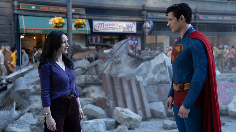 Rachel Brosnahan as Lois Lane standing face to face with David Corenswet as Supereman amongst the rubble on the street in Superman