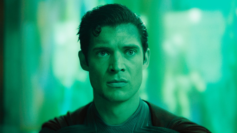 David Corenswet as Superman bathed in green light in Superman