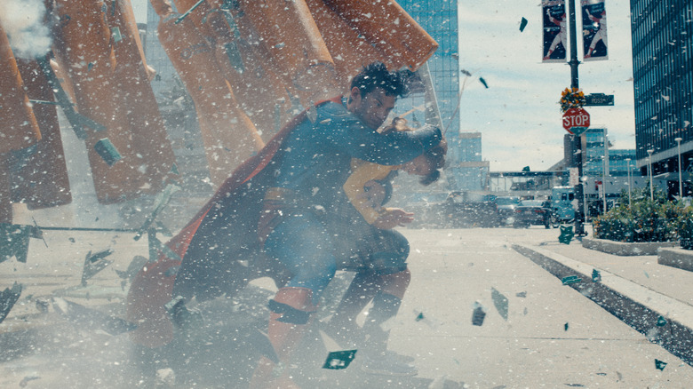 Supeman saves a girl from falling debris in Superman