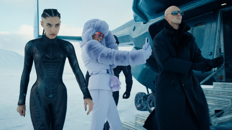Eve Teschmacher, Lex Luthor, and the engineer walks towards the isolation castle in Superman