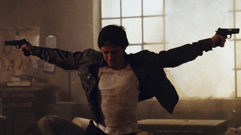 James McAvoy as Wesley holding out his pistols on his sides with his eyes closed in Wanted