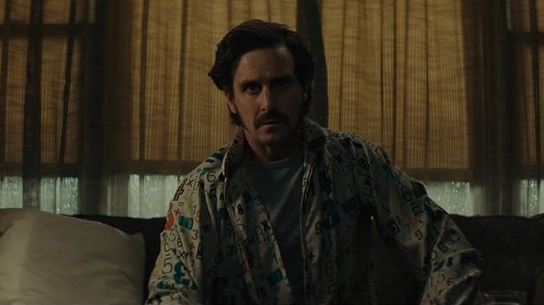 James Ransone as Max sitting on the couch in The Black Phone