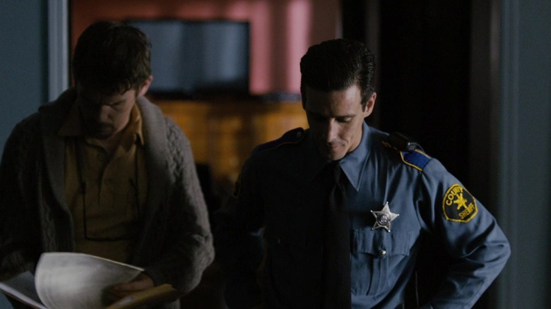 Ethan Hawke as Ellison looking at some papers with James Ransone as Deputy So and So in Sinister