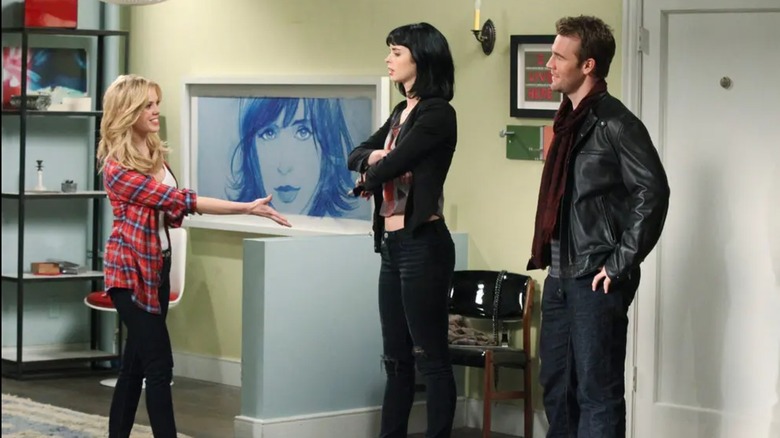 June holding a hand out to Chloe and James in the living room on Don't Trust the B in Apartment 23