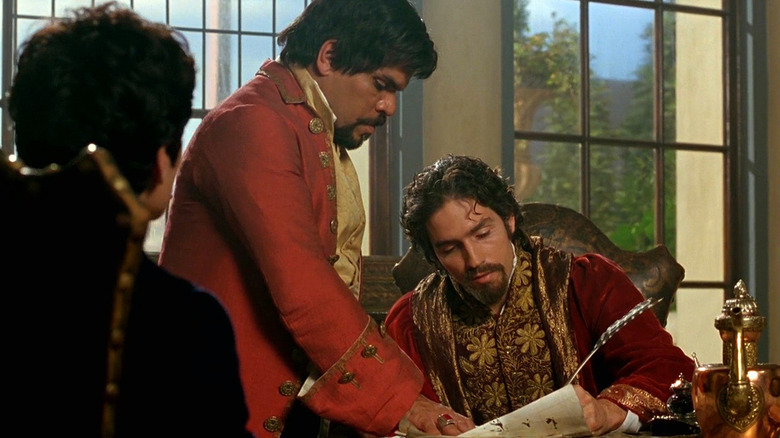 Jim Caviezel signs document with quill