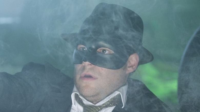 Seth Rogen aims gun in fog