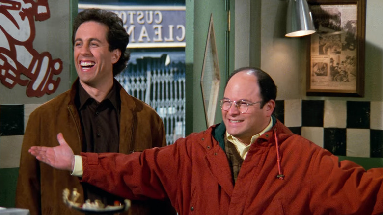 Jerry Sinfield and George Costanza smiling at a pizza store in Sinfield