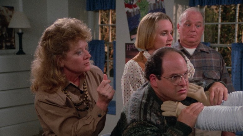 George getting strangled by the Bubble Boy while his family looks on in Seinfeld.