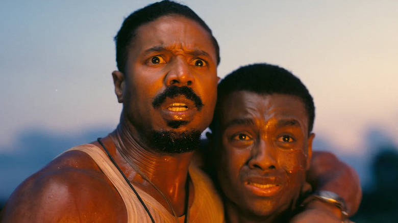 Smoke and Sammie looking at something scary in Sinners