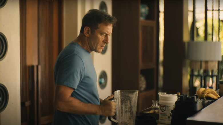 Jason Isaacs as Timothy Ratliff holding a blender in 