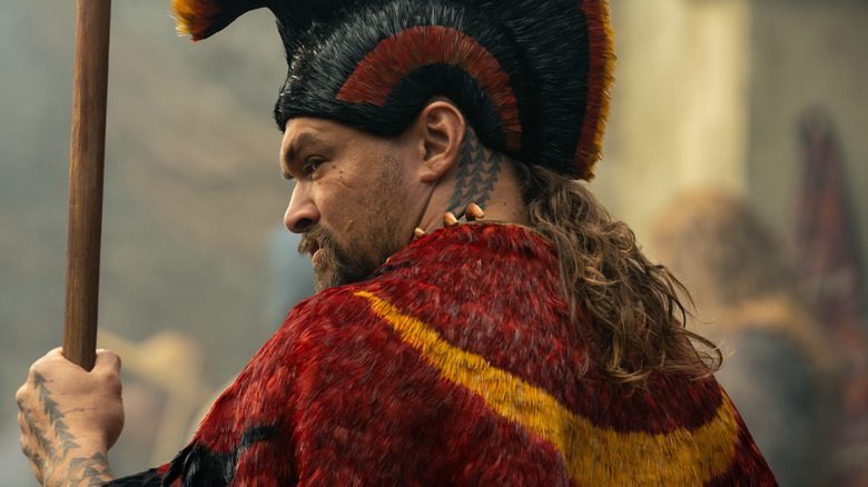 Kaʻiana holding spear looking over shoulder