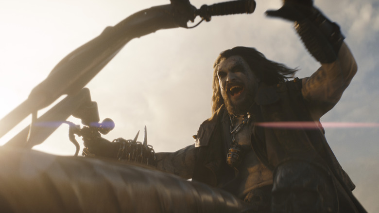 Jason Momoa as Lobo riding his motorcycle with a pleased expression on his face in Supergirl