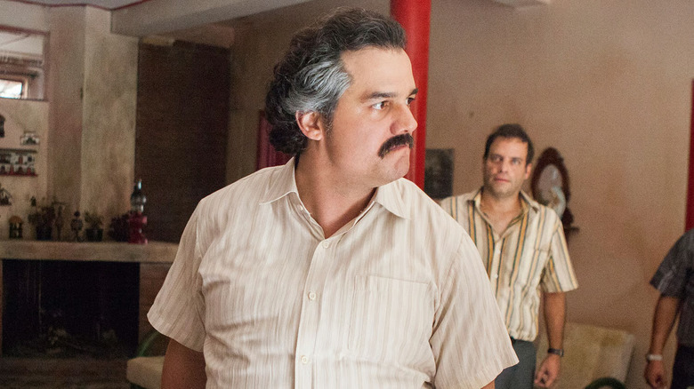 Wagner Moura as Pablo Escobar looking angry with his mustache in Narcos