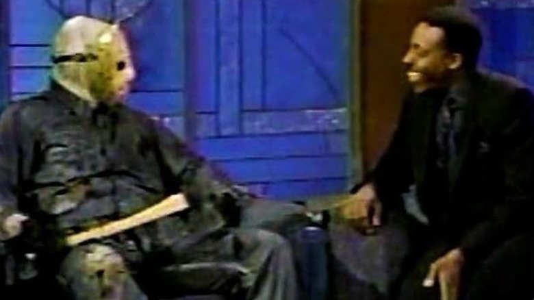 An unknown actor as Jason Voorhees silently banters with Arsenio Hall on The Arsenio Hall Show
