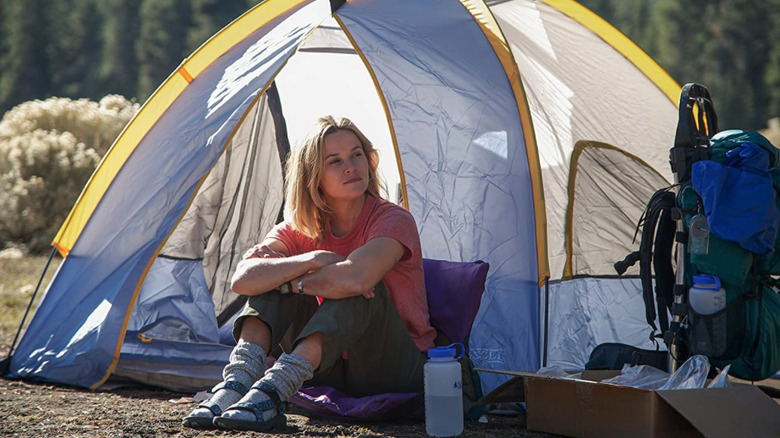 Reese Witherspoon sitting in front of her tent