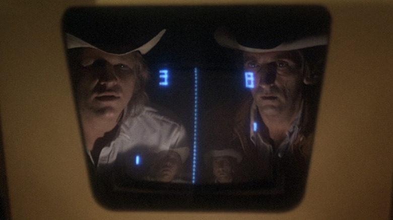 Jeff Bridges' Jack McKee and Sam Waterston's Cecil Colson peer at a video game screen in Rancho Deluxe