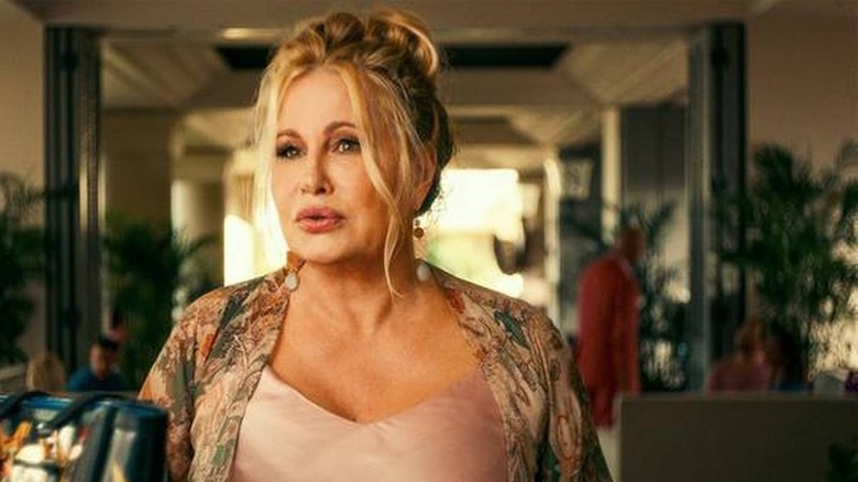 woman in a multicolored robe and beige top looking concerned