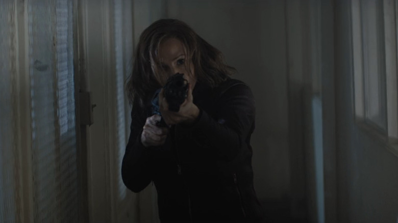 Riley North Jennifer Garner aims at a pistol in mint